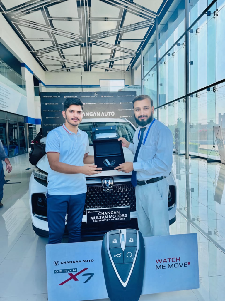 Saqib Jatoi receiving the keys to his first car, a Changan Oshan X7, at Changan Multan Motors